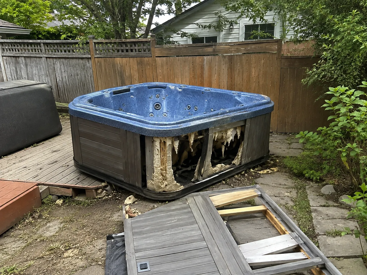 Just Dump It crew removing an old hot tub from a backyard in Old Lyme, CT